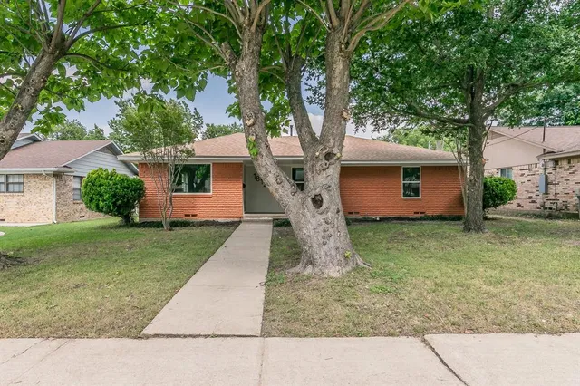 a front view of house with a garden