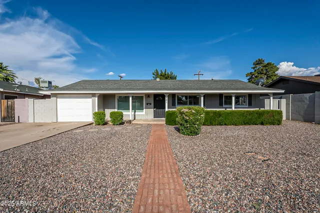 a front view of a house with a garden