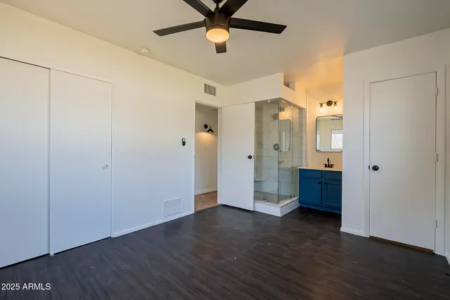 a view of an empty room with wooden floor