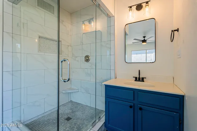 a bathroom with a shower a sink and mirror