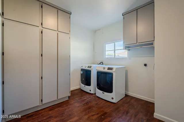 a view of a storage and utility room with washer and dryer
