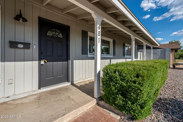 a view of a house with a backyard