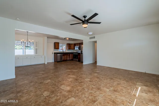 a view of a livingroom with a ceiling fan and window