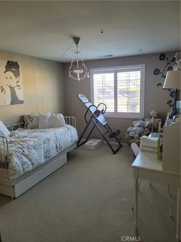 a bedroom with bed couch and window