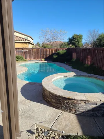 a view of a swimming pool with a yard