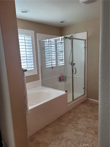 a spacious bathroom with a bathtub and shower