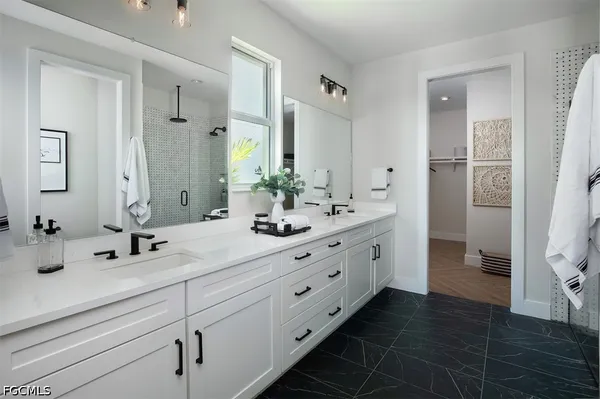 a bathroom with double sink and a mirror