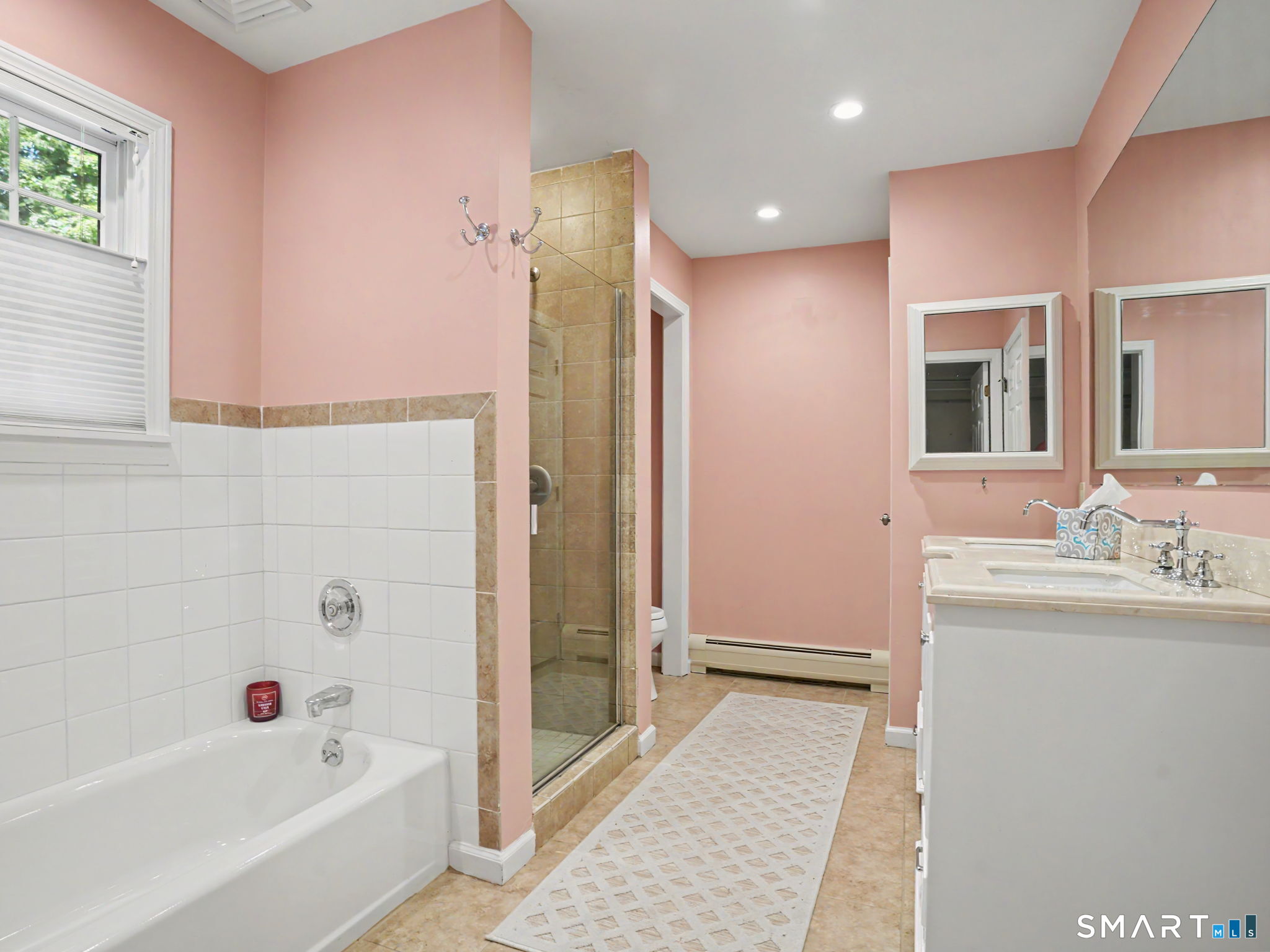 26 Abbott Avenue Ridgefield, CT 06877 - Photo 32 of 40 Nice primary bathroom with walk-in shower, bathtub, double sinks and entry to walk-in closet. There are two closets in the primary bedroom