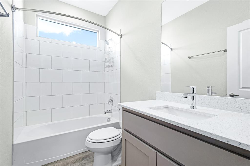 15501 Balham Path Fort Worth, TX 76247 - Photo 11 of 22 a bathroom with a sink a toilet and shower
