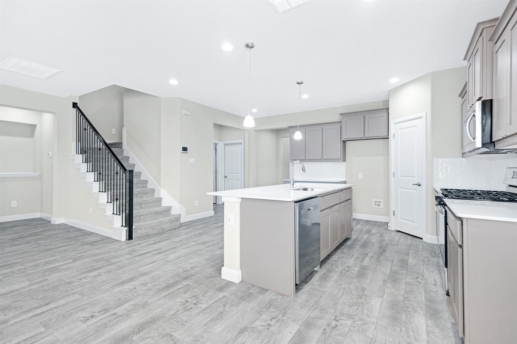 15501 Balham Path Fort Worth, TX 76247 - Photo 4 of 22 a view of kitchen with sink microwave and refrigerator