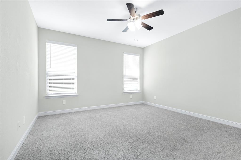 15501 Balham Path Fort Worth, TX 76247 - Photo 7 of 22 an empty room with a window and a fan
