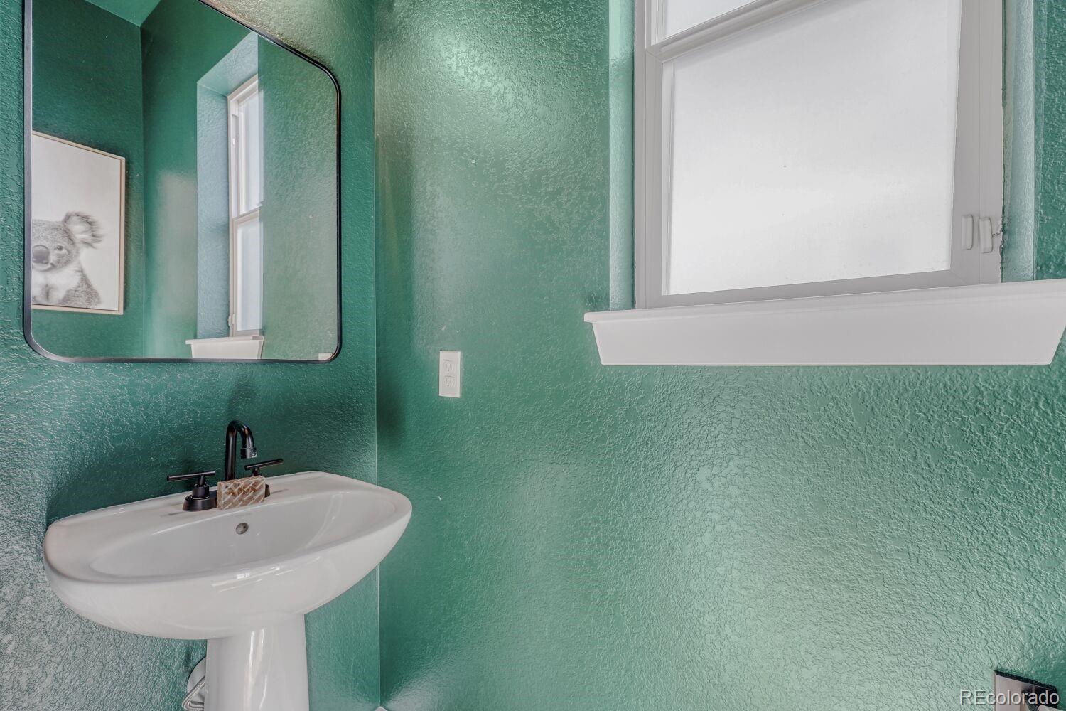 2861 Lima Street Denver, CO 80238 - Photo 16 of 45 a bathroom with a sink and a mirror