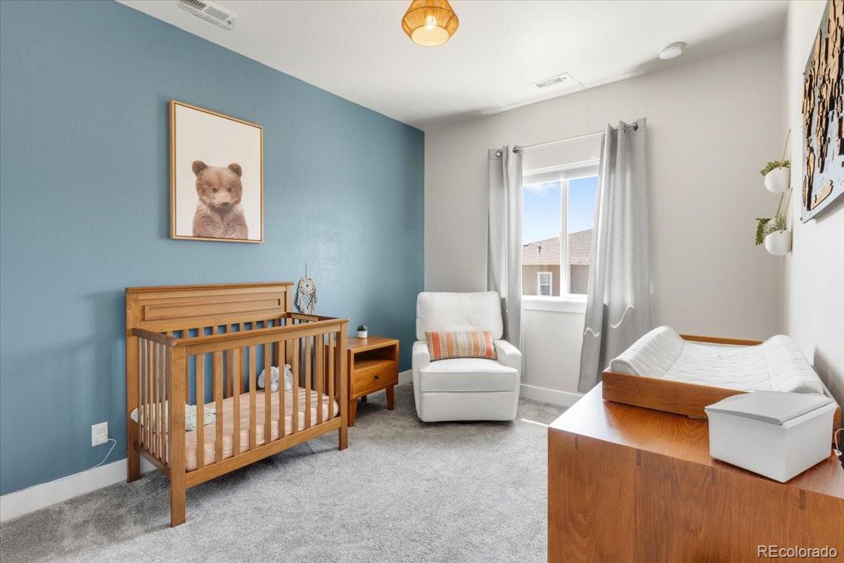 2861 Lima Street Denver, CO 80238 - Photo 22 of 45 a bedroom with furniture and a couch