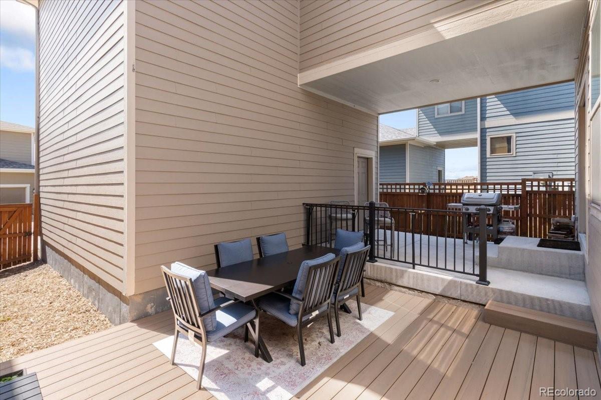 2861 Lima Street Denver, CO 80238 - Photo 36 of 45 a view of a patio with table and chairs with wooden floor and fence