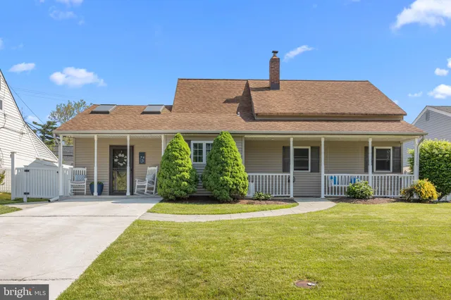 a front view of a house with a garden and plants