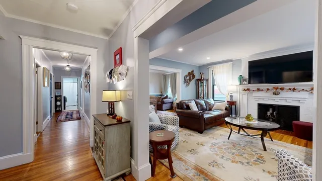 a living room with furniture a rug and a chandelier