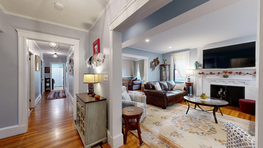 101 King Street, Unit 101 Reading, MA 01867 - Photo 11 of 33 a living room with furniture a flat screen tv and a fireplace