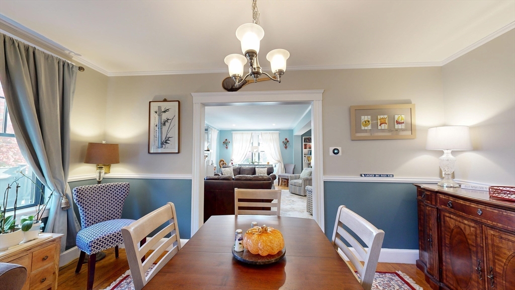 101 King Street, Unit 101 Reading, MA 01867 - Photo 13 of 33 a view of a dining room with furniture a chandelier and a window