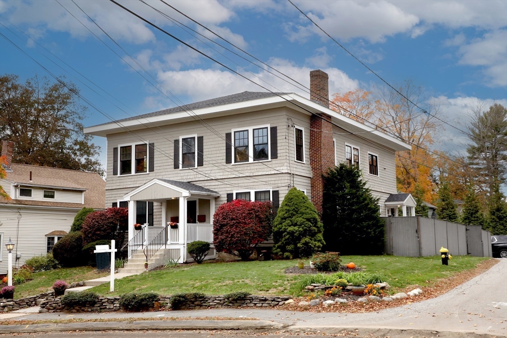 101 King Street, Unit 101 Reading, MA 01867 - Photo 2 of 33 a front view of a house with a yard