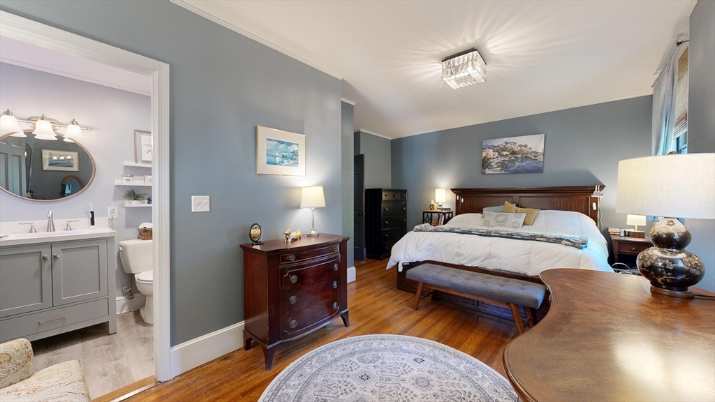 101 King Street, Unit 101 Reading, MA 01867 - Photo 26 of 33 a bedroom with a bed and wooden floor