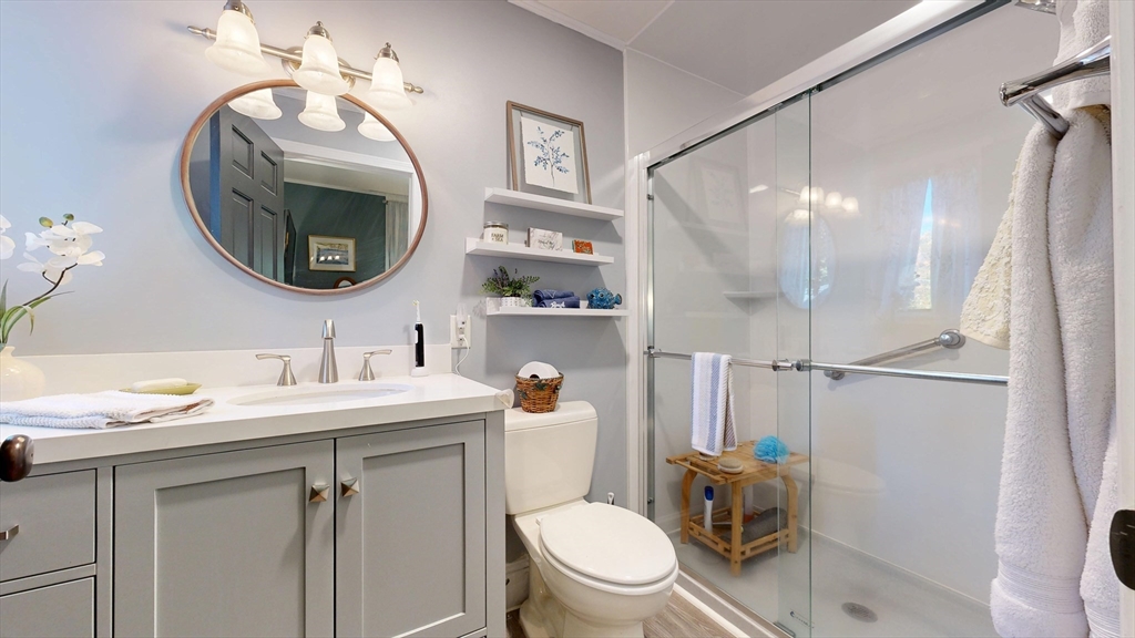 101 King Street, Unit 101 Reading, MA 01867 - Photo 27 of 33 a bathroom with a toilet a sink and a mirror