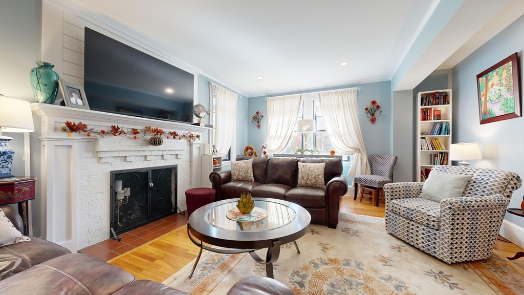 101 King Street, Unit 101 Reading, MA 01867 - Photo 9 of 33 a living room with furniture a flat screen tv and a fireplace