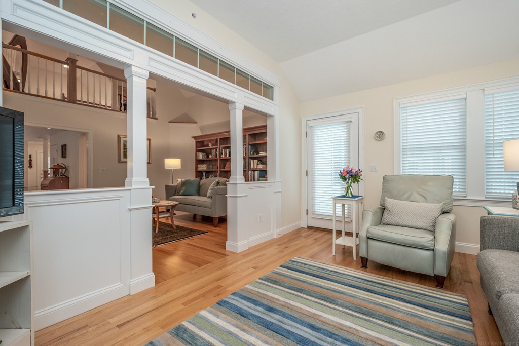 1094 Hill Road, Unit 1094 Boxborough, MA 01719 - Photo 17 of 38 a living room with furniture and a wooden floor