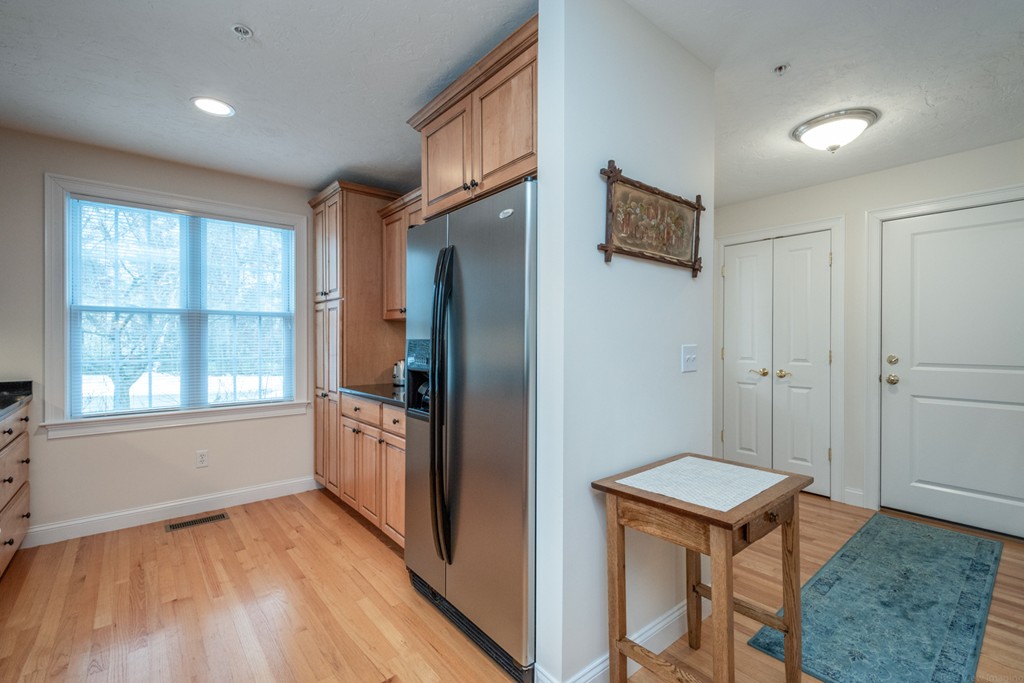 1094 Hill Road, Unit 1094 Boxborough, MA 01719 - Photo 6 of 38 a kitchen with stainless steel appliances granite countertop a refrigerator and a stove top oven