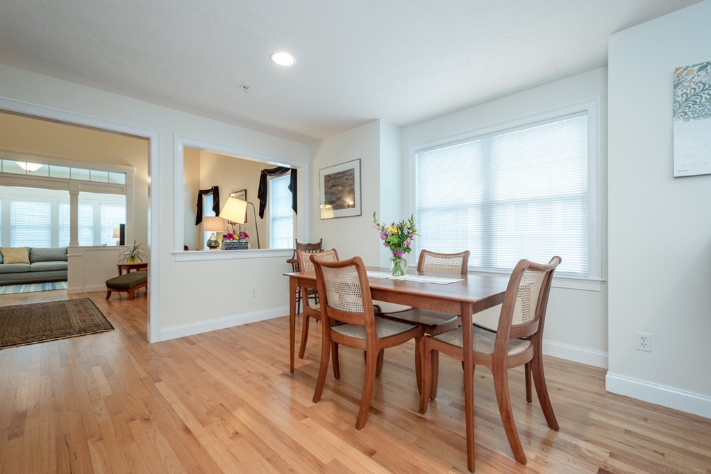 1094 Hill Road, Unit 1094 Boxborough, MA 01719 - Photo 10 of 38 a view of a dining room with furniture and wooden floor