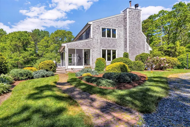 a front view of a house with a yard table and chairs