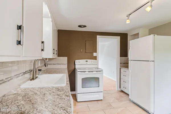 a kitchen with a stove sink and refrigerator