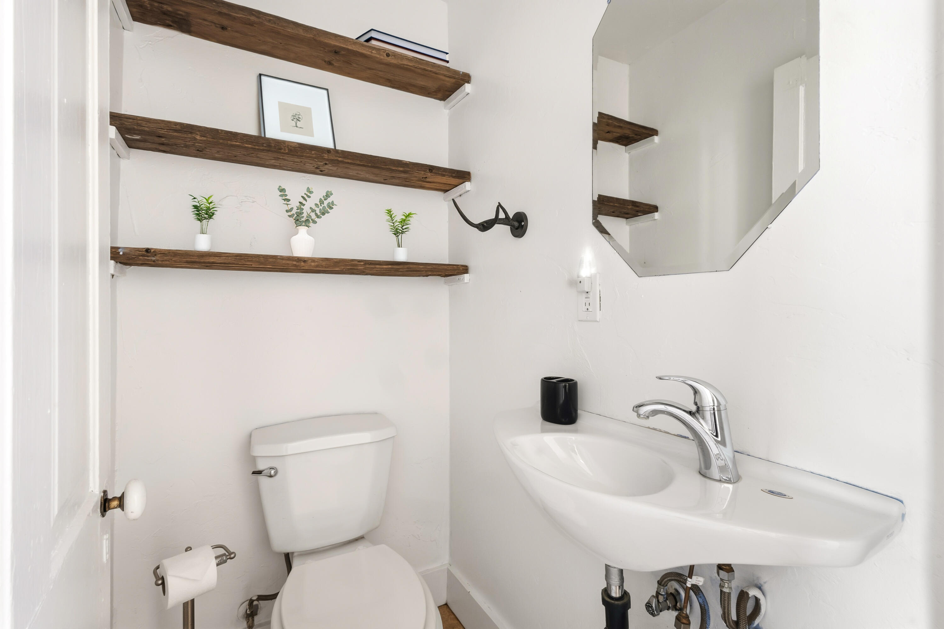 a bathroom with a toilet sink and mirror