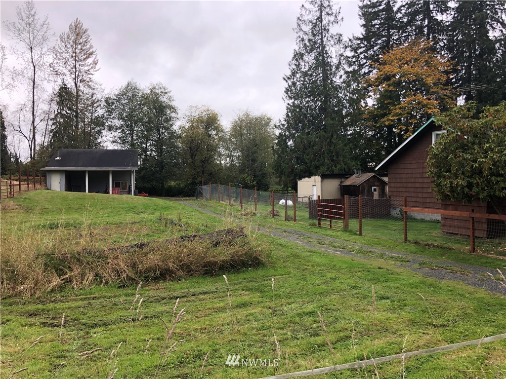 17706 Butler Road Snohomish, WA 98290 - Photo 17 of 22 a backyard of a house with table and chairs