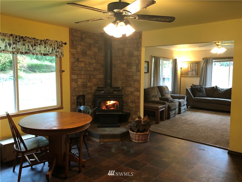 17706 Butler Road Snohomish, WA 98290 - Photo 6 of 22 a living room with furniture a lamp and a fireplace