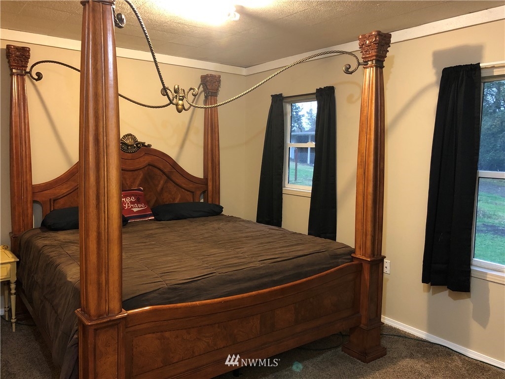 17706 Butler Road Snohomish, WA 98290 - Photo 10 of 22 a bed room with a bed window and a mirror