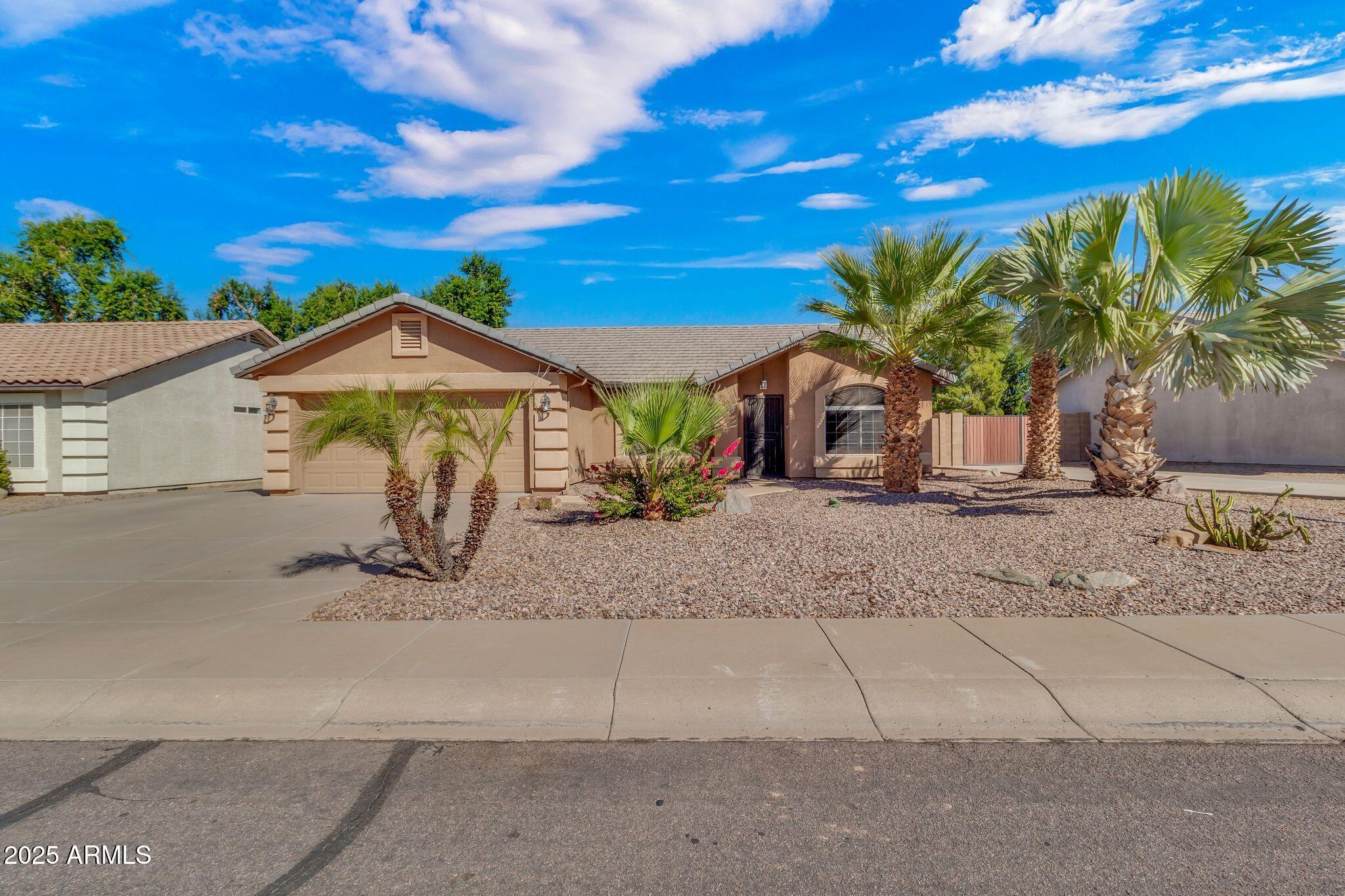 3048 East Erie Street Gilbert, AZ 85295 - Photo 1 of 44 a view of a house with a yard and potted plants