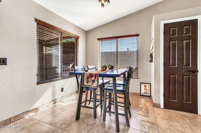 a view of a dining room with furniture and window