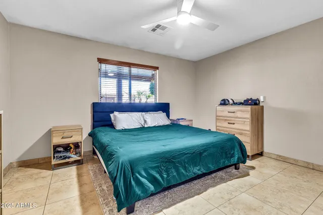 a bedroom with a bed and window