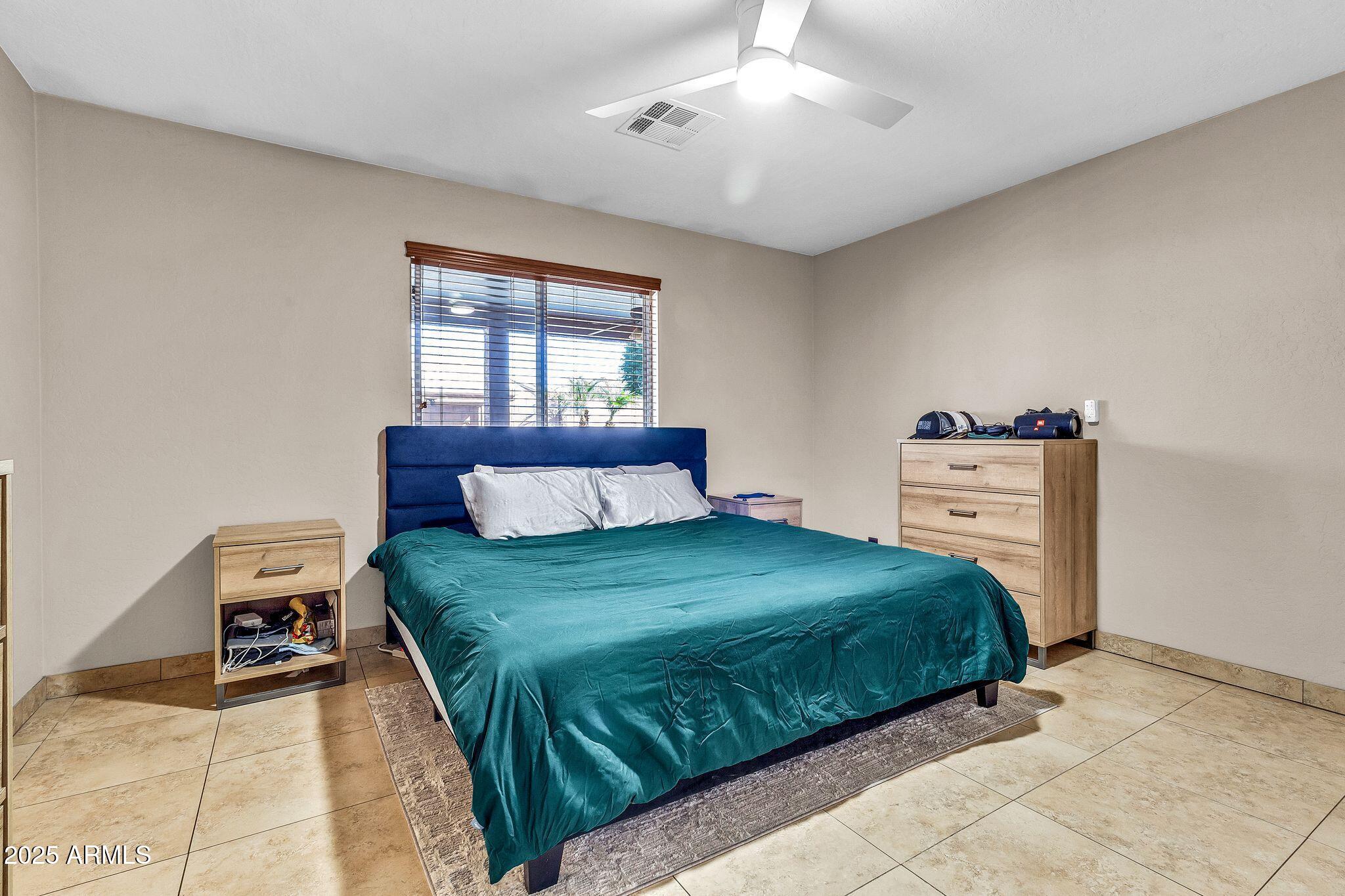 3048 East Erie Street Gilbert, AZ 85295 - Photo 18 of 44 a bedroom with a bed and window