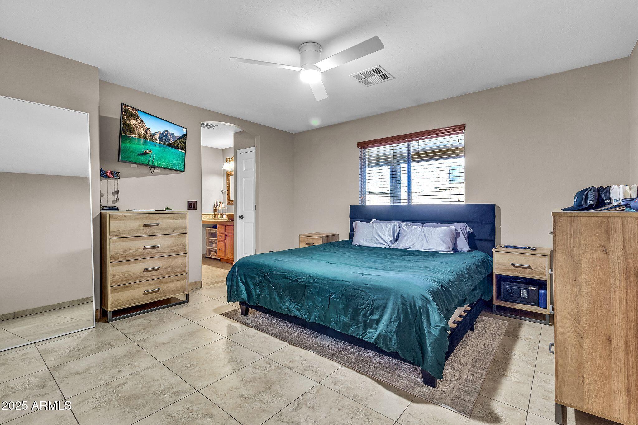 3048 East Erie Street Gilbert, AZ 85295 - Photo 19 of 44 a bedroom with a bed and a window