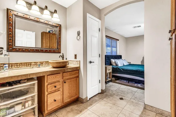 a bathroom with a sink a toilet and a mirror