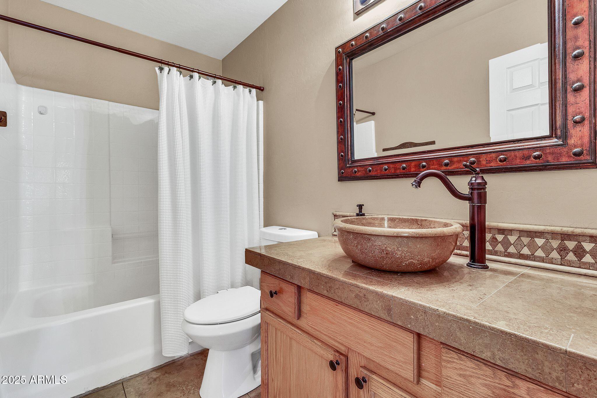 3048 East Erie Street Gilbert, AZ 85295 - Photo 22 of 41 a bathroom with a granite countertop sink a toilet and a mirror