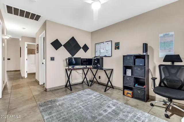 a view of a livingroom with furniture and a workspace