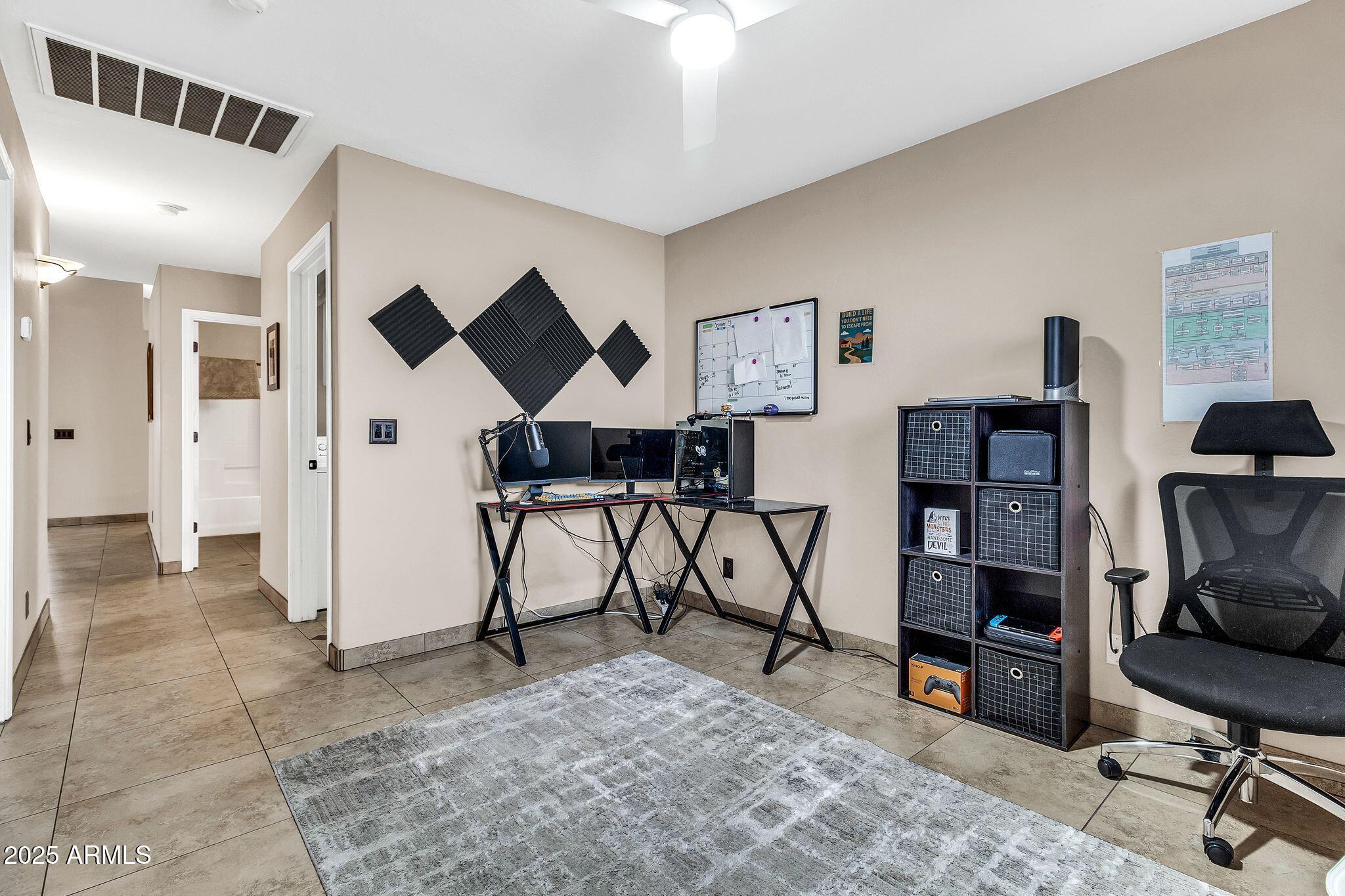 3048 East Erie Street Gilbert, AZ 85295 - Photo 22 of 44 a view of a livingroom with furniture and a workspace
