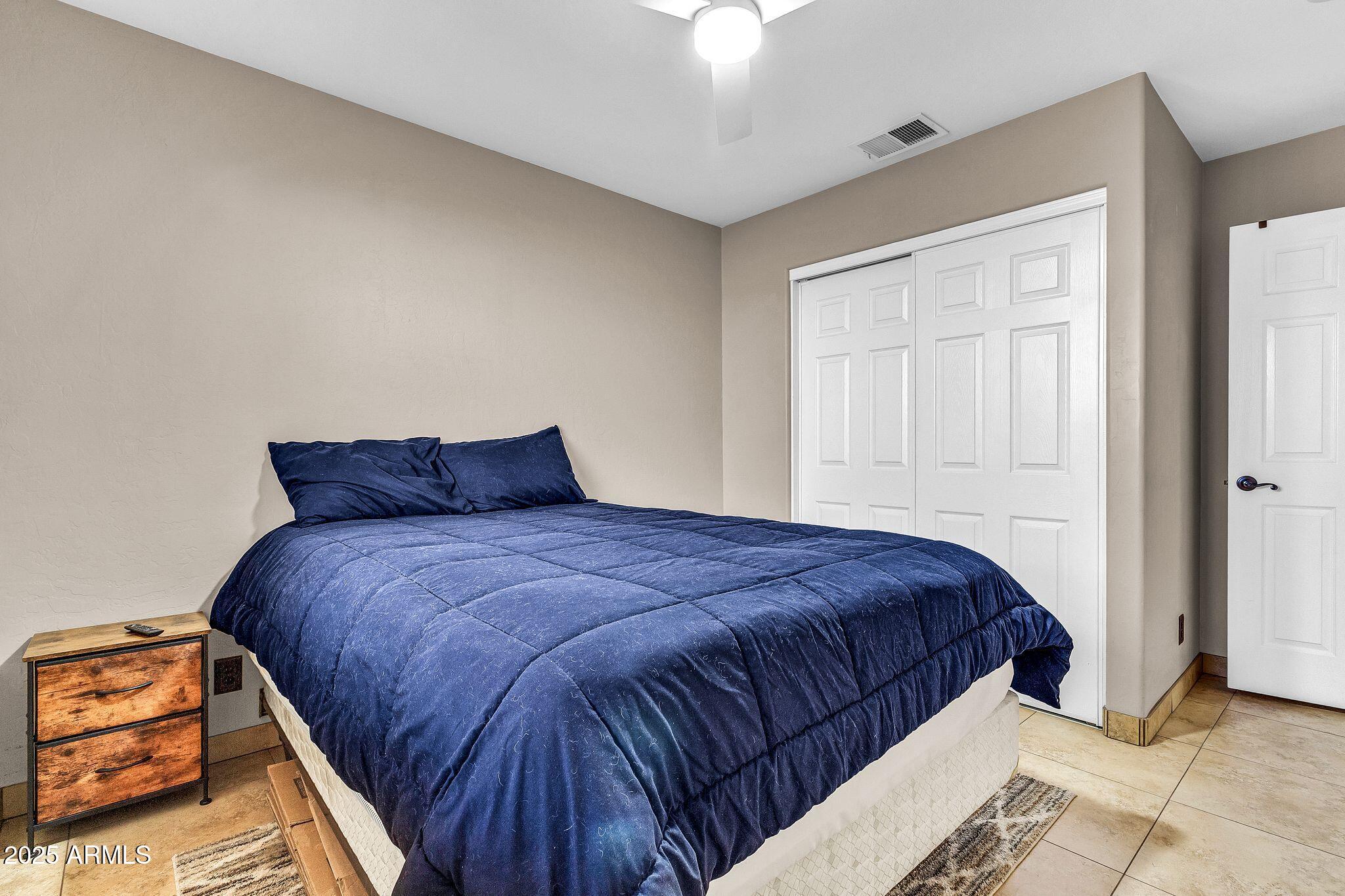 3048 East Erie Street Gilbert, AZ 85295 - Photo 23 of 41 a bedroom with bed and window