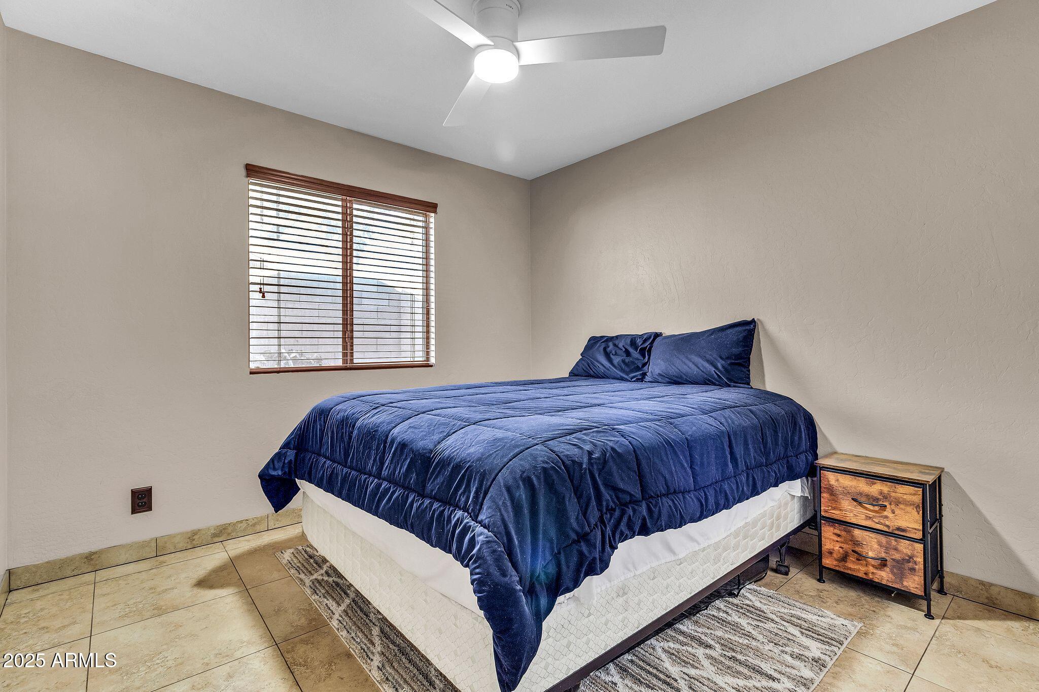 3048 East Erie Street Gilbert, AZ 85295 - Photo 27 of 44 a bedroom with a bed and window