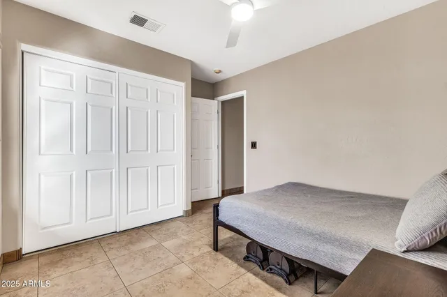 a living room with furniture and a ceiling fan