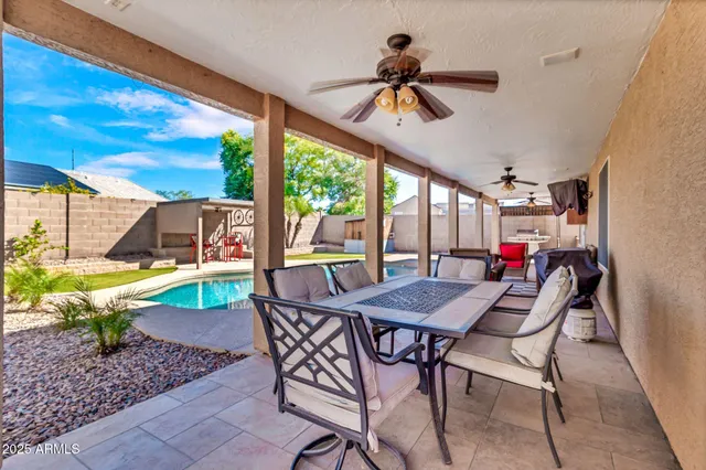 a living room with furniture a floor to ceiling window and a flat screen tv