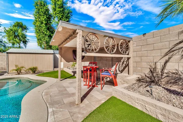 a view of a house with swimming pool and sitting area