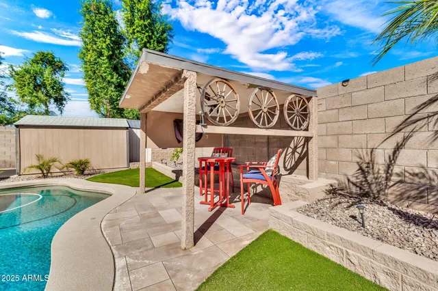 a view of a house with swimming pool and sitting area